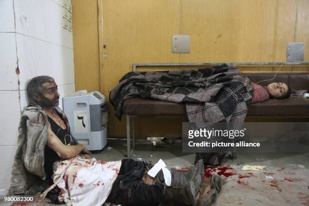 Dpatop - Syrians receive first aid in a makeshift hospital after he was injured during air strikes by forces loyal to Syrian President Assad in Kafr...