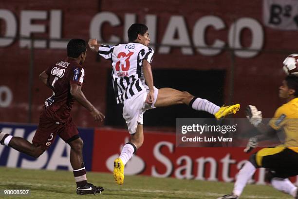 Rodolfo Gamarra from Paraguay?s Libertad vies for the ball with Antonio Gonzalez and Raul Fernandez of Peru?s Universitario de Lima,during their...