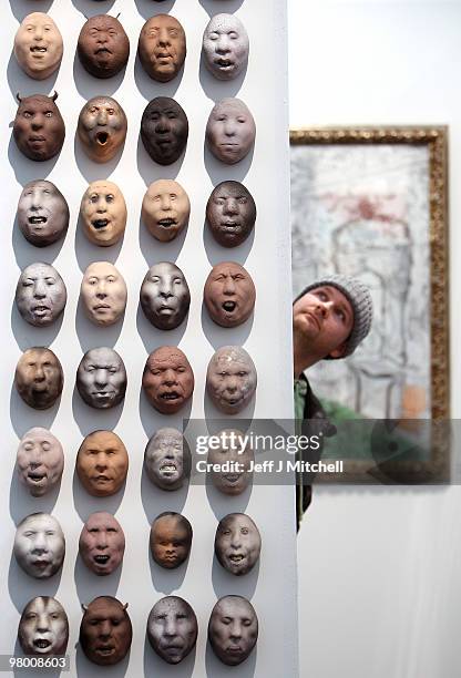 An exhibitor views ceramic heads by Johan Thunell at Glasgow Art Fair on March 24, 2010 in Glasgow, Scotland. Held in George Square in the heart of...