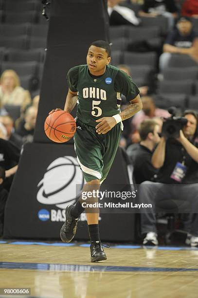 Cooper of the Ohio University Bobcats dribbles up court during the first round of NCAA Men's Basketball Championship against the Georgetown Hoyas on...