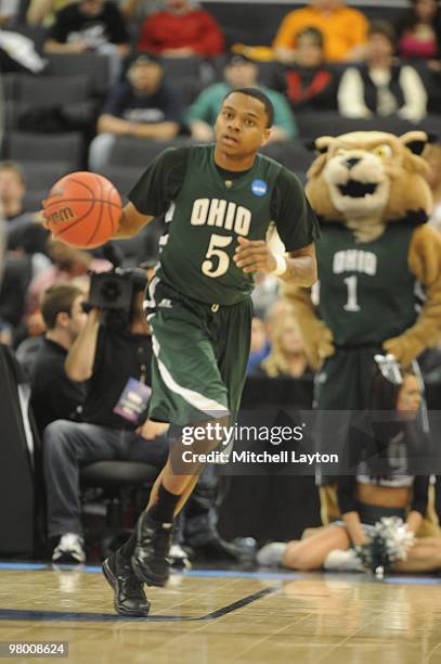 Cooper of the Ohio University Bobcats dribbles up court during the first round of NCAA Men's Basketball Championship against the Georgetown Hoyas on...