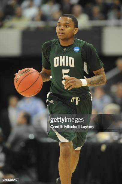 Cooper of the Ohio University Bobcats dribbles up court during the first round of NCAA Men's Basketball Championship against the Georgetown Hoyas on...