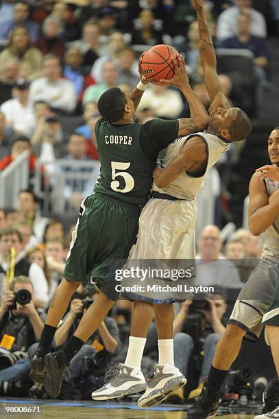 Cooper of the Ohio University Bobcats takes a shot over Jason Clark of the Georgetown Hoyas during the first round of NCAA Men's Basketball...