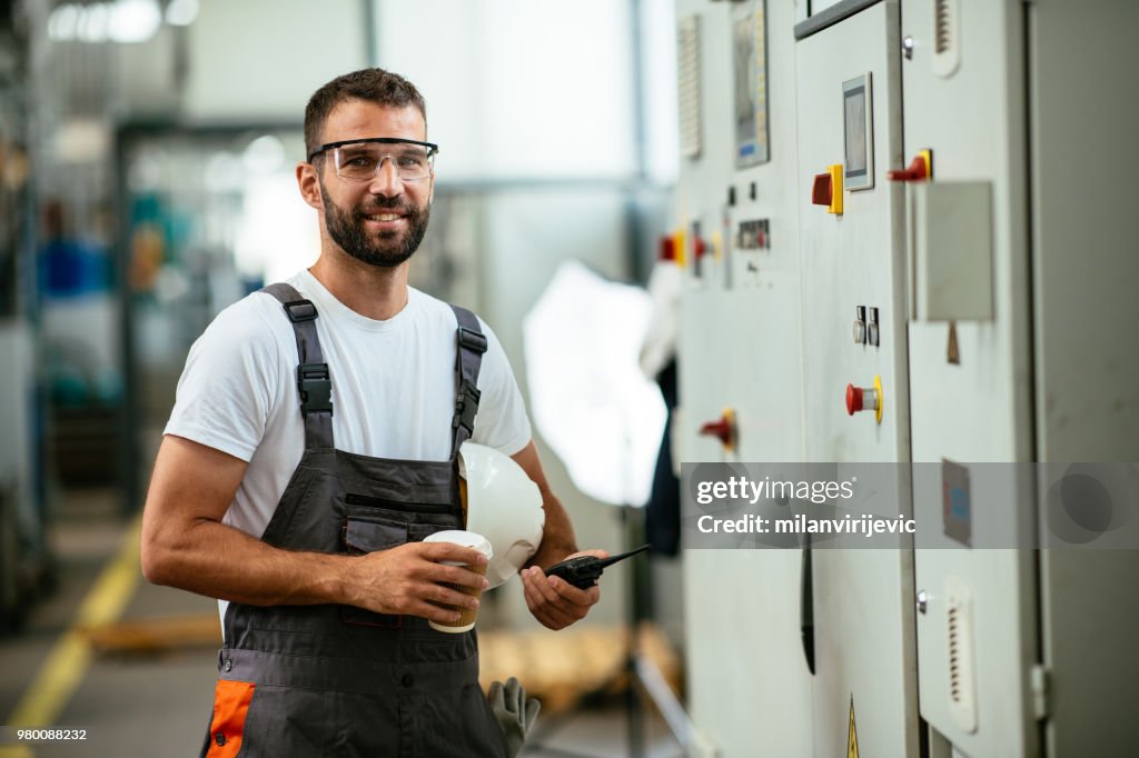 Technician in power substation on coffee break