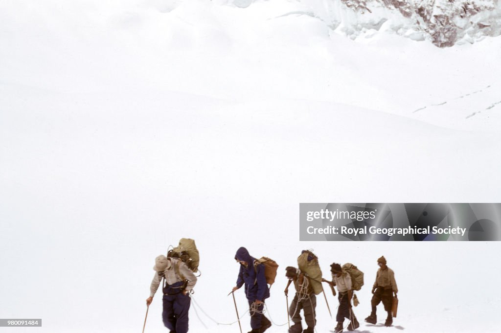 John Hunt leading a group across snow in the Western Cwm