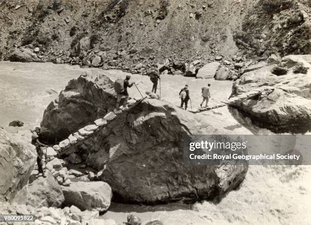 Bridge over Gori-Ganga rapids below Martoli on the way to Tola and Ralam, Uttar Pradesh, India, 1926.