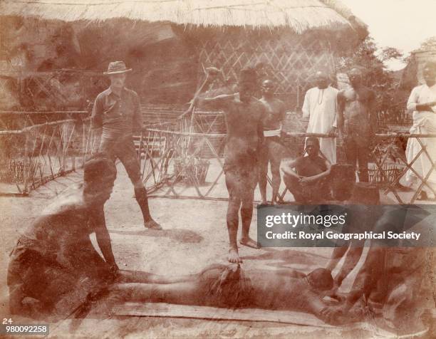 British traveller watching a slave being beaten, Democratic Republic of the Congo, 1898.