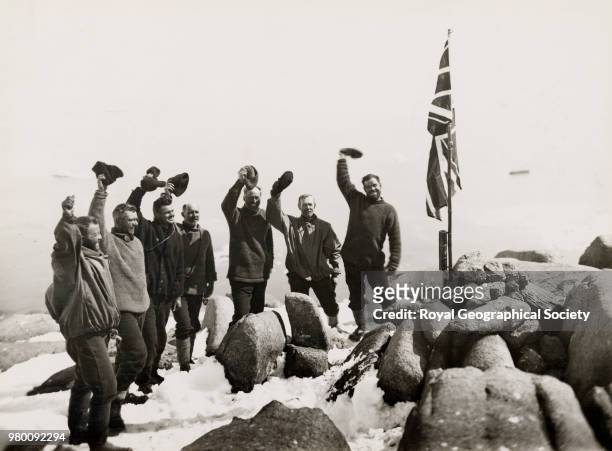 Cheering the flag on the summit of Proclamation Island, 13th January 1930 - the ship is faintly outlined, in the distance some 800 feet below, Harold...