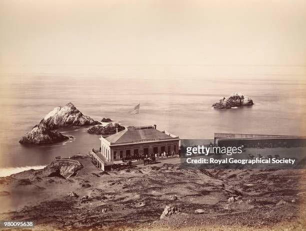 Cliff House and Seal Rock - near Farallons Islands, This photograph shows horses and carriages on a path in front of Cliff House, San Francisco and a...