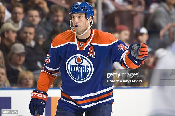 Jason Strudwick of the Edmonton Oilers concentrates on the puck during a game against the Vancouver Canucks at Rexall Place on March 23, 2010 in...