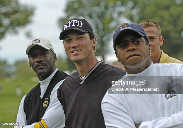 Amhad Rashad, Mario Lemieux and Michael Jordan watch four-ball competition at the 2004 Ryder Cup in Detroit, Michigan, September 17, 2004.