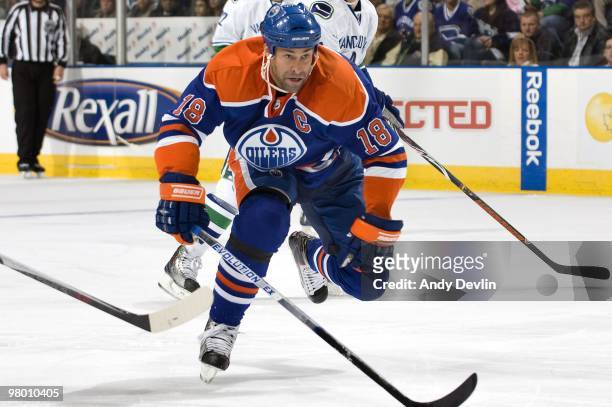 Ethan Moreau of the Edmonton Oilers forechecks against the Vancouver Canucks at Rexall Place on March 23, 2010 in Edmonton, Alberta, Canada. The...