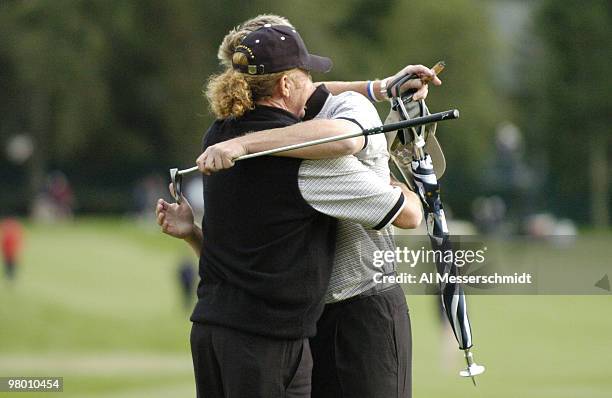 Miguel Angel Jimenez hugs Darren Clarke after competition at the 2004 Ryder Cup in Detroit, Michigan.