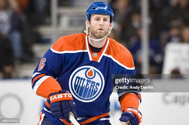 Ryan Whitney of the Edmonton Oilers concentrates on the puck during a game against the Vancouver Canucks at Rexall Place on March 23, 2010 in...