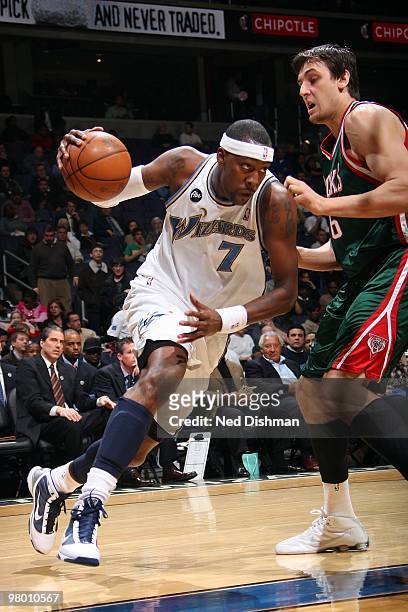 Andray Blatche of the Washington Wizards drives against Andrew Bogut of the Milwaukee Bucks during the game on March 5, 2010 at the Verizon Center in...