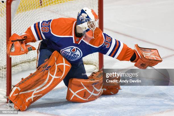 Jeff Deslauriers of the Edmonton Oilers makes a save against the Vancouver Canucks at Rexall Place on March 23, 2010 in Edmonton, Alberta, Canada....