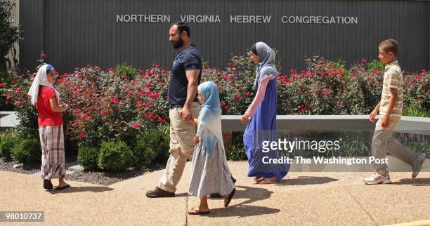 Family walks into the synagogue for Friday Muslim prayers at the Northern Virginia Hebrew Congregation in Reston, Virginia on Friday, August 21,...