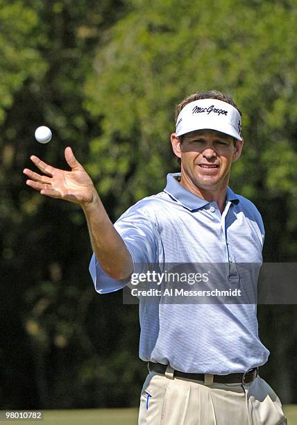 Lee Janzen snags a toss from his caddy at the 2004 Chrysler Championship final round October 31, 2004 in Palm Harbor, Florida.