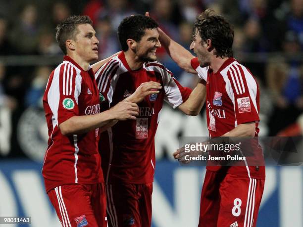 Thomas Rathgeber of Unterhaching celebrates with his team mates after scoring his team's first goal during the 3. Liga match between Holstein Kiel v...
