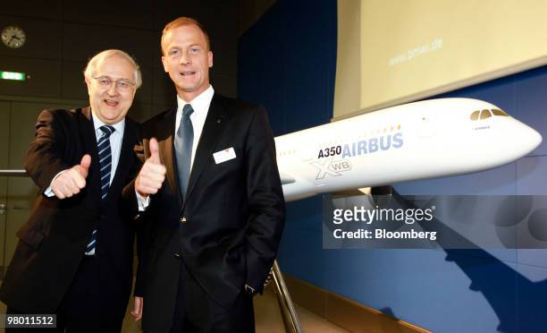 Rainer Bruederle, Germany's minister of economy, left, and Tom Enders, chief executive officer of Airbus SAS, pose in front on a model of an Airbus...