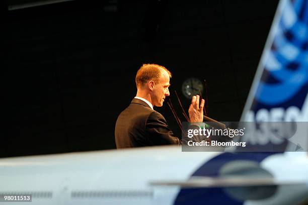 Tom Enders, chief executive officer of Airbus SAS, speaks from behind a model Airbus A350 jet at an air travel technology exhibition in Berlin,...