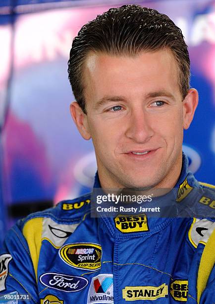 Allmendinger, driver of the RPM Ford, looks on in the garage during NASCAR Sprint Cup Series testing at Charlotte Motor Speedway on March 24, 2010 in...