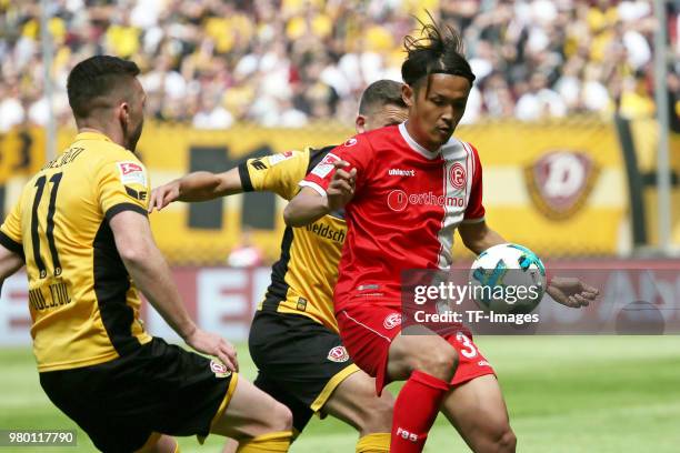 Haris Duljevic of Dresden, Takashi Usami of Duesseldorf battle for the ball during the Second Bundesliga match between SG Dynamo Dresden and Fortuna...