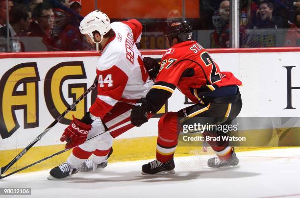 Steve Staios of the Calgary Flames skates against Todd Bertuzzi of the Detroit Red Wings on March 15, 2010 at Pengrowth Saddledome in Calgary,...