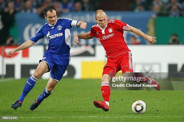 Heiko Westermann of Schalke challenges Arjen Robben of Bayern during the DFB Cup semi final match between FC Schalke 04 and FC Bayern Muenchen at...