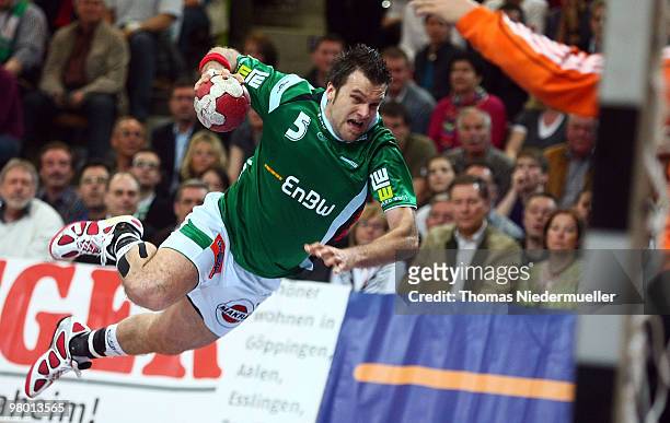 Dragos-Nicolae Oprea of Goeppingen scores during the Handball Bundesliga match between Frisch Auf Goeppingen and THW Kiel at the EWS Arena on March...