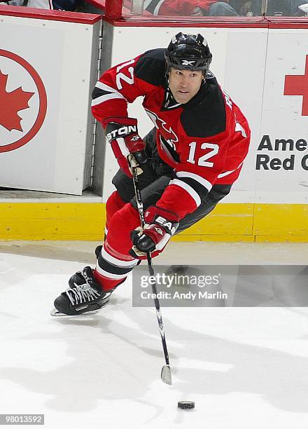 Brian Rolston of the New Jersey Devils plays the puck against the Columbus Blue Jackets during the game at the Prudential Center on March 23, 2010 in...