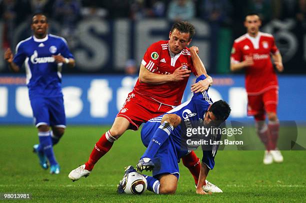 Ivica Olic of Muenchen challenges Carlos Zambrano of Schalke during the DFB Cup semi final match between FC Schalke 04 and FC Bayern Muenchen at...