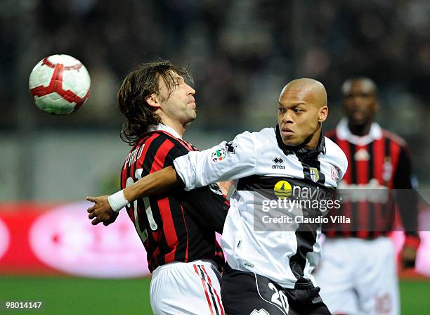 Andrea Pirlo of AC Milan competes for the ball with Jonathan Biabiany of Parma FC during the Serie A match between Parma FC and AC Milan at Stadio...