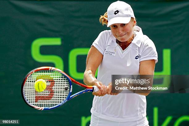 Ekaterina Makarova of Russia returns a shot against Casey Dellacqua of Australia during day two of the 2010 Sony Ericsson Open at Crandon Park Tennis...