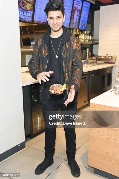 Britain's Got Talent semi-finalist, illusionist Maddox Dixon astonishes the customers as he performs during the launch of the new Smashburger on June...