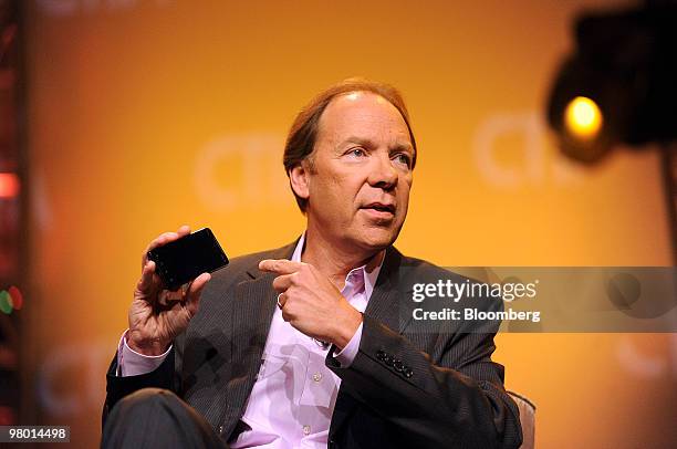 Dan Hesse, chief executive officer of Sprint Nextel Corp., holds the Sprint HTC Evo 4G smartphone while speaking at the CTIA Wireless conference in...