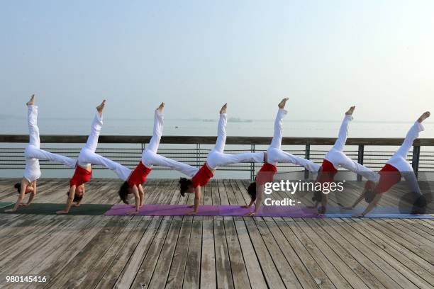 People attend a yoga session to mark International Yoga Day in Huaibei in China's eastern Anhui province on June 21, 2018. / China OUT