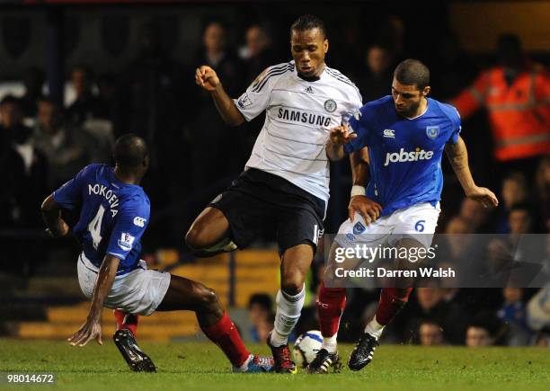 Aaron Mokoena and Ricardo Carvalho of Portsmouth challenge Didier Drogba of Chelsea during the Barclays Premier League match between Portsmouth and...