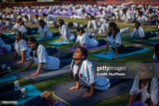 Kashmiri students perform Yoga exercise in their camp on June 21 in Srinagar, the summer capital of Indian administered Kashmir, India. Yoga, which...