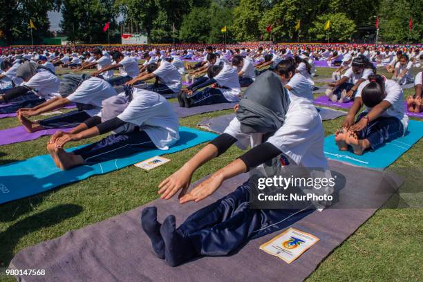 Kashmiri students perform Yoga exercise in their camp on June 21 in Srinagar, the summer capital of Indian administered Kashmir, India. Yoga, which...