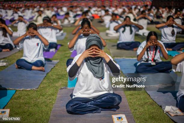 Kashmiri students perform Yoga exercise in their camp on June 21 in Srinagar, the summer capital of Indian administered Kashmir, India. Yoga, which...