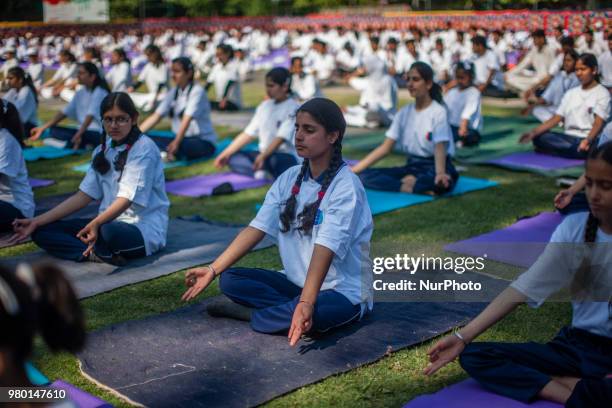 Kashmiri students perform Yoga exercise in their camp on June 21 in Srinagar, the summer capital of Indian administered Kashmir, India. Yoga, which...