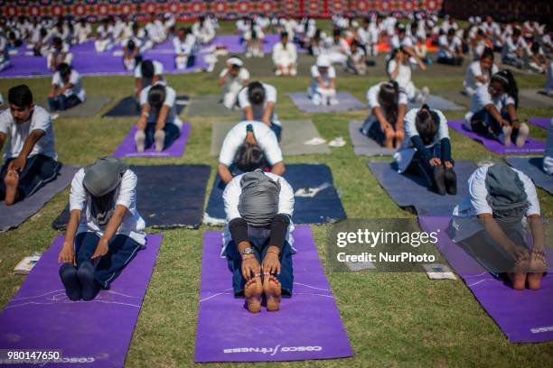 Kashmiri students perform Yoga exercise in their camp on June 21 in Srinagar, the summer capital of Indian administered Kashmir, India. Yoga, which...