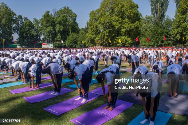 Kashmiri students perform Yoga exercise in their camp on June 21 in Srinagar, the summer capital of Indian administered Kashmir, India. Yoga, which...