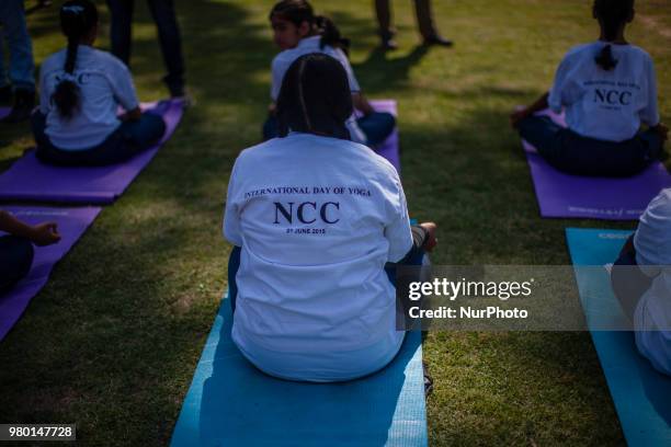 Kashmiri students perform Yoga exercise in their camp on June 21 in Srinagar, the summer capital of Indian administered Kashmir, India. Yoga, which...