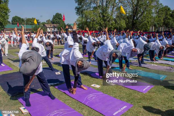 Kashmiri students perform Yoga exercise in their camp on June 21 in Srinagar, the summer capital of Indian administered Kashmir, India. Yoga, which...