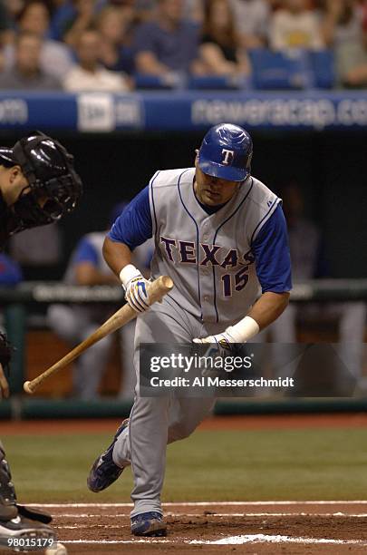 Texas Rangers catcher Gerald Laird runs out a third strike in the dirt against Tampa Bay Devil Rays pitcher Scott Kazmir August 22, 2006 in St....