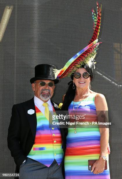 Brian Mann and Rebecca Johnson wearing multicoloured outfits during day three of Royal Ascot at Ascot Racecourse.