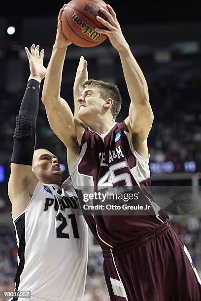 Nathan Walkup of the Texas A&M Aggies shoots against D.J. Byrd of the Purdue Boilermakers during the second round of the 2010 NCAA men's basketball...