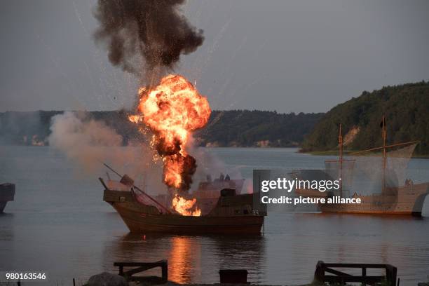 June 2018, Germany, Ralswiek: A naval battle with medieval cogs can be seen at a press screening on the Jasmund bay on the island Ruegen at the...